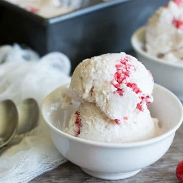 a scoop of white chocolate raspberry ice cream in a small white bowl