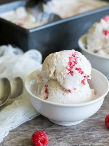a scoop of white chocolate raspberry ice cream in a small white bowl