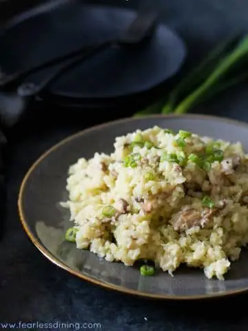 a grey plate filled with riced cauliflower risotto