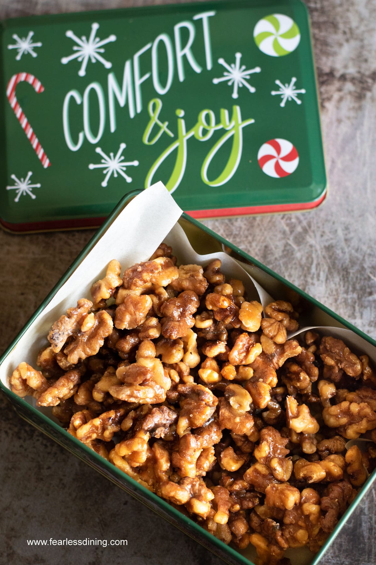 A Christmas tin filled with cinnamon spiced walnuts.