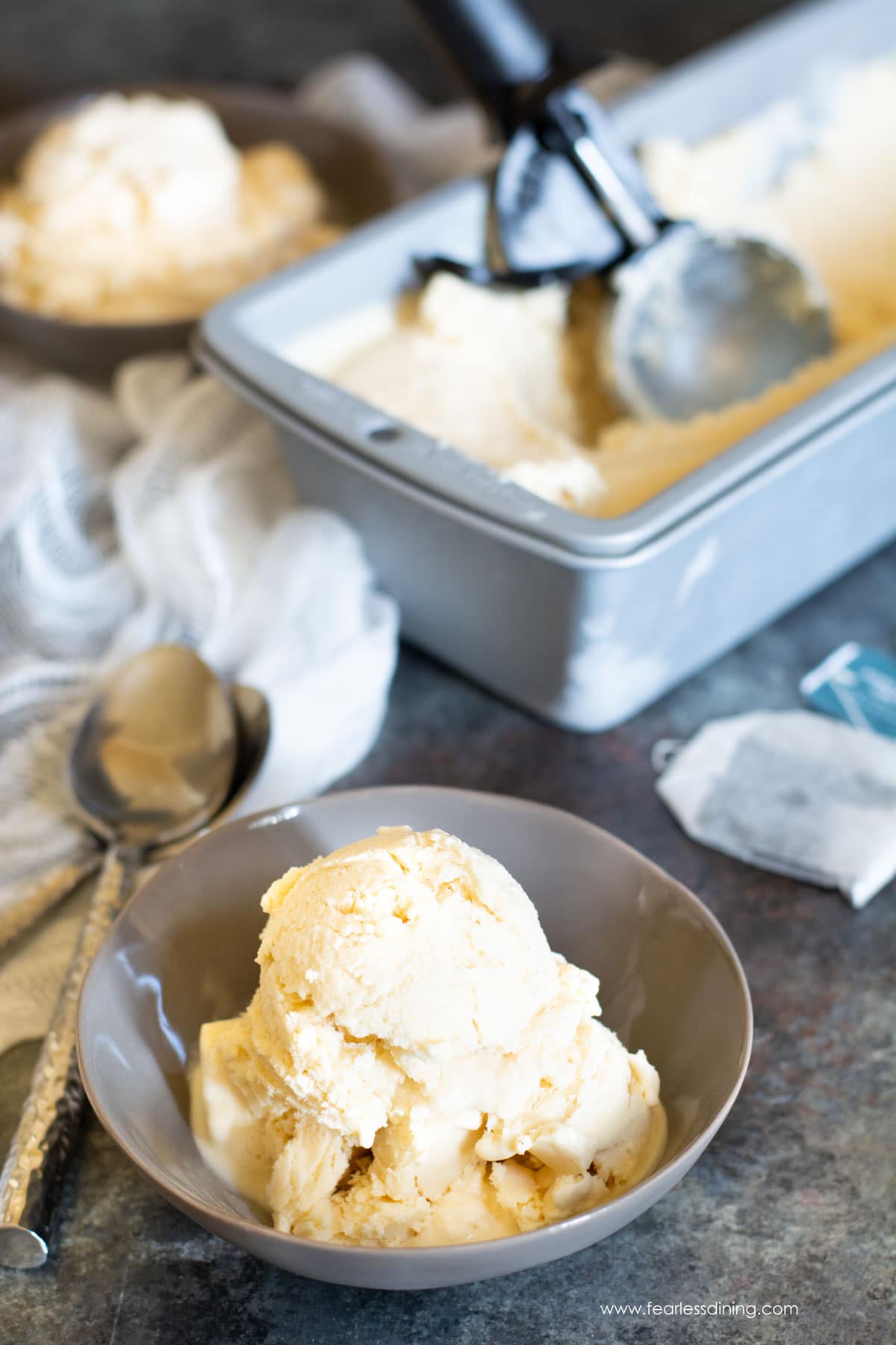Earl grey ice cream scoops in small grey bowls.