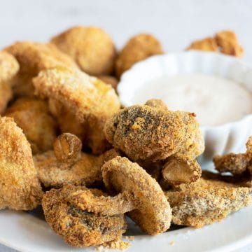 air fried mushrooms on a plate with dip