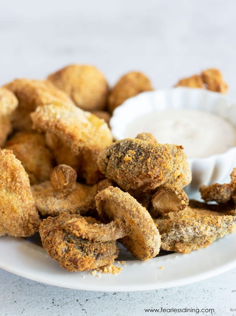 Air fried mushrooms on a plate with dip.