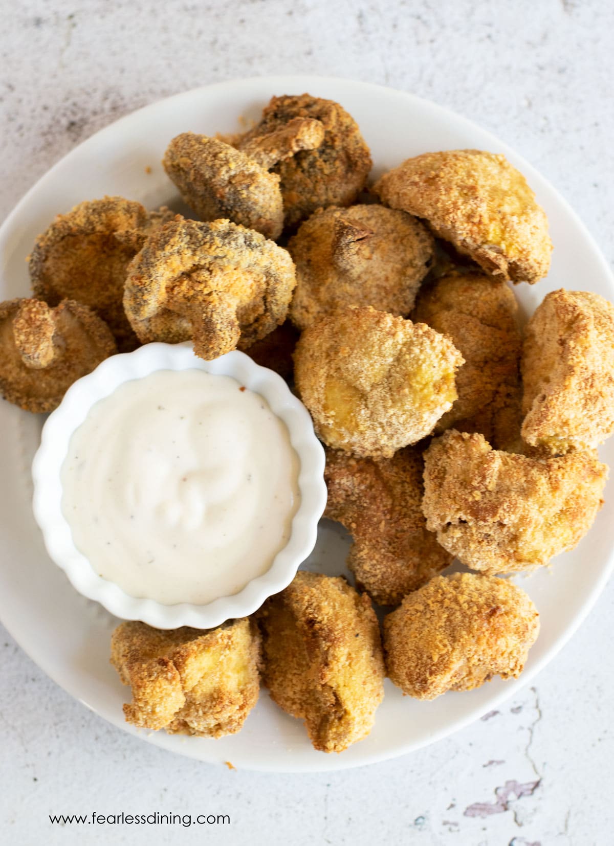 The top view of a platter of fried mushrooms.