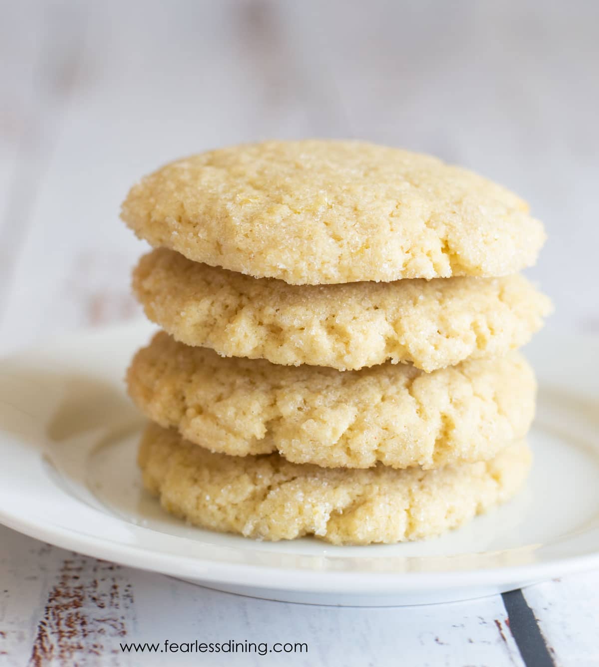 A stack of lemon cookies on a plate.