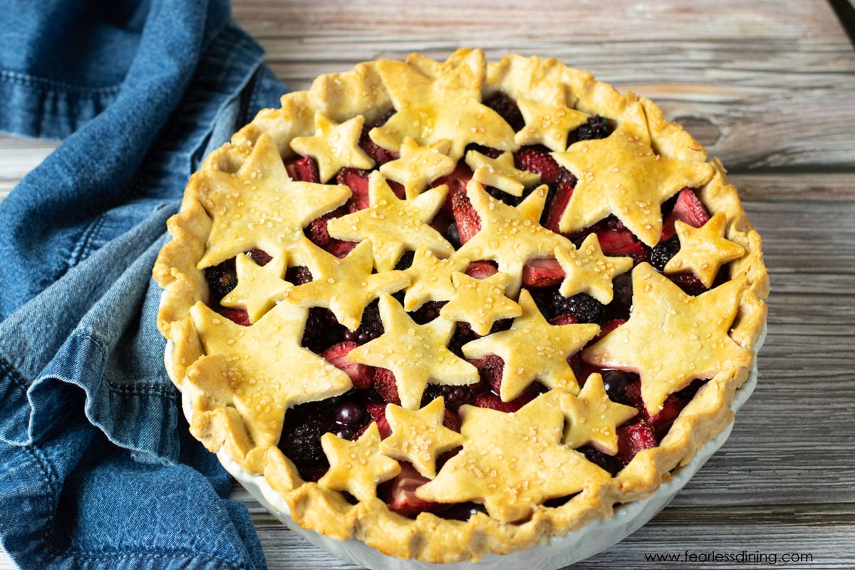 A baked mixed berry pie on a picnic table.