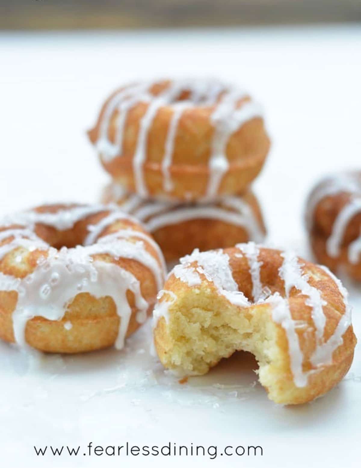 Several stacks of iced lemon donuts.