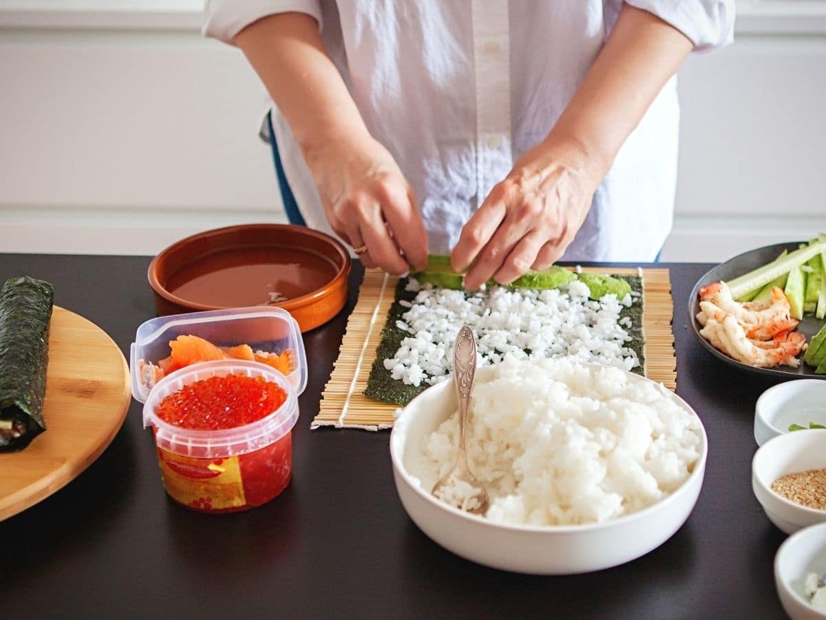 Making sushi on a counter.