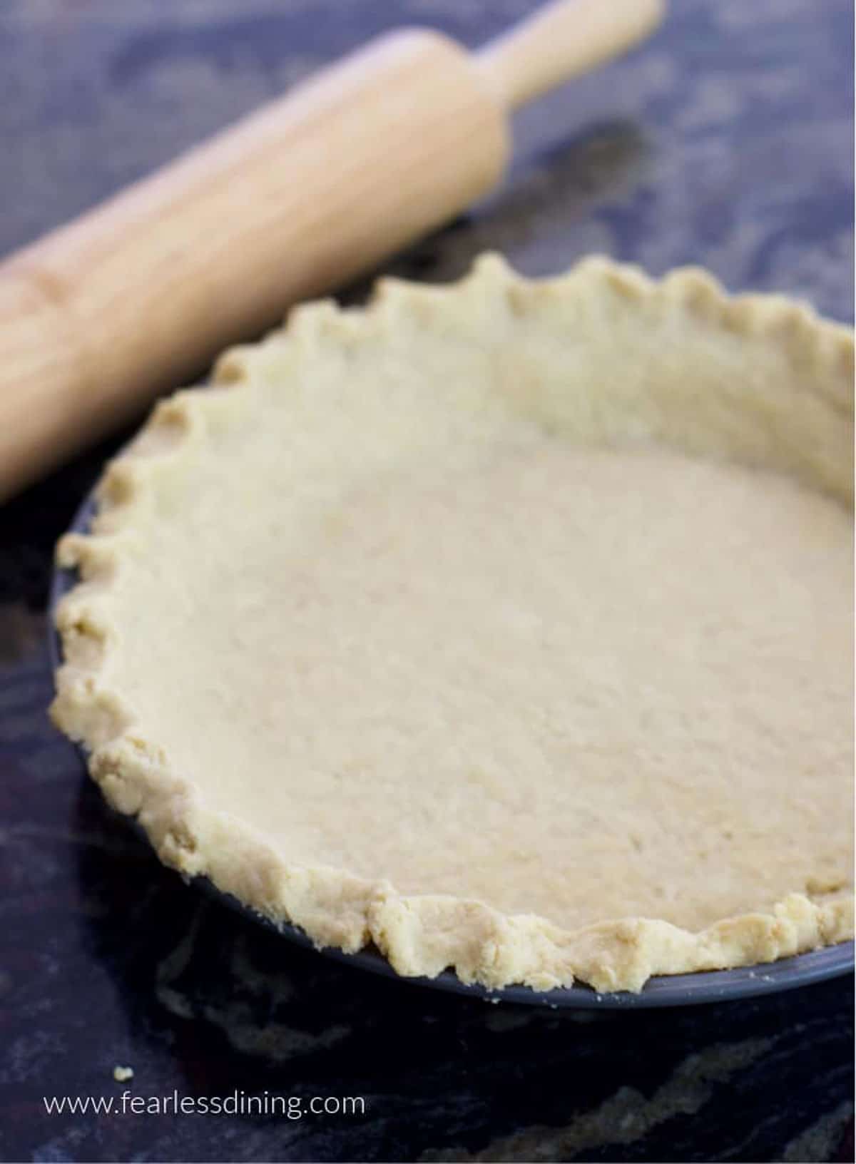 A baked gluten free pie crust on the counter.