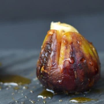 A single brown grilled fig stuffed with brie.