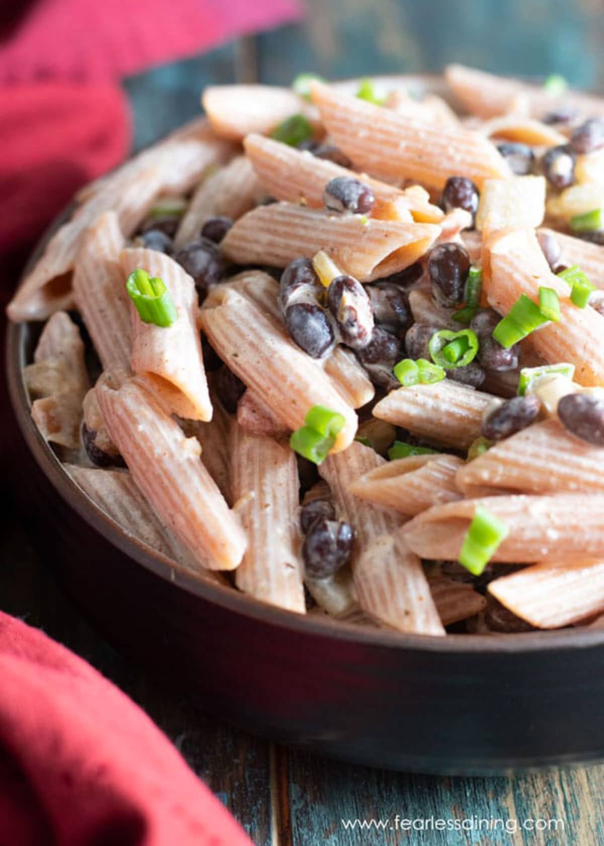 a bowl full of red lentil pasta salad
