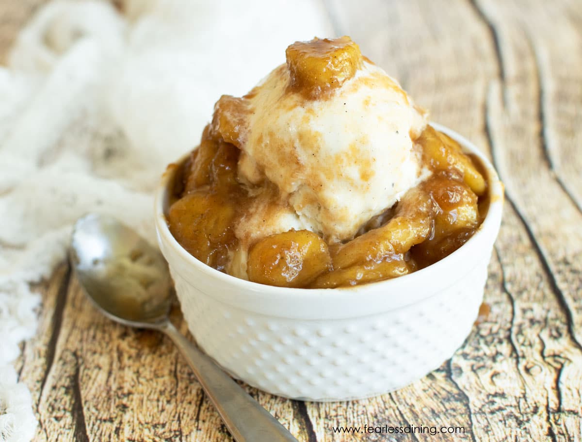 A bowl of vanilla ice cream topped with caramelized banana slices.