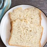 Two slices of gluten free bread machine bread on a plate.