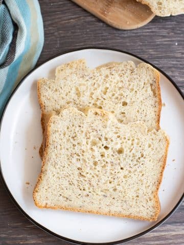 Two slices of gluten free bread on a plate.
