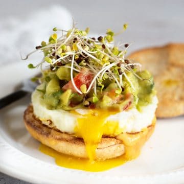 A gluten free breakfast sandwich on a white plate.