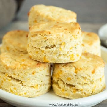 a plate stacked with gluten free cheddar biscuits