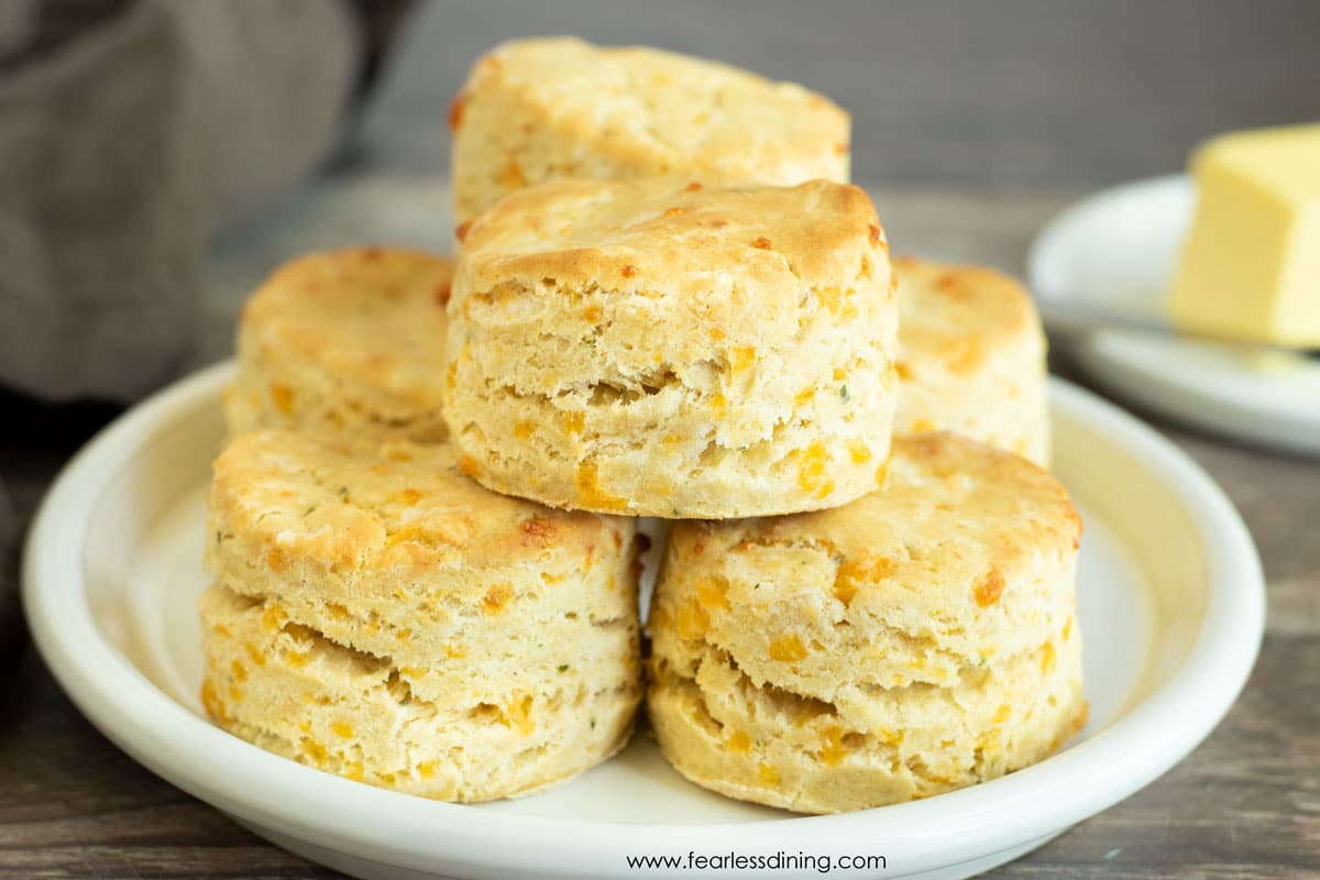 a plate stacked with gluten free cheddar biscuits