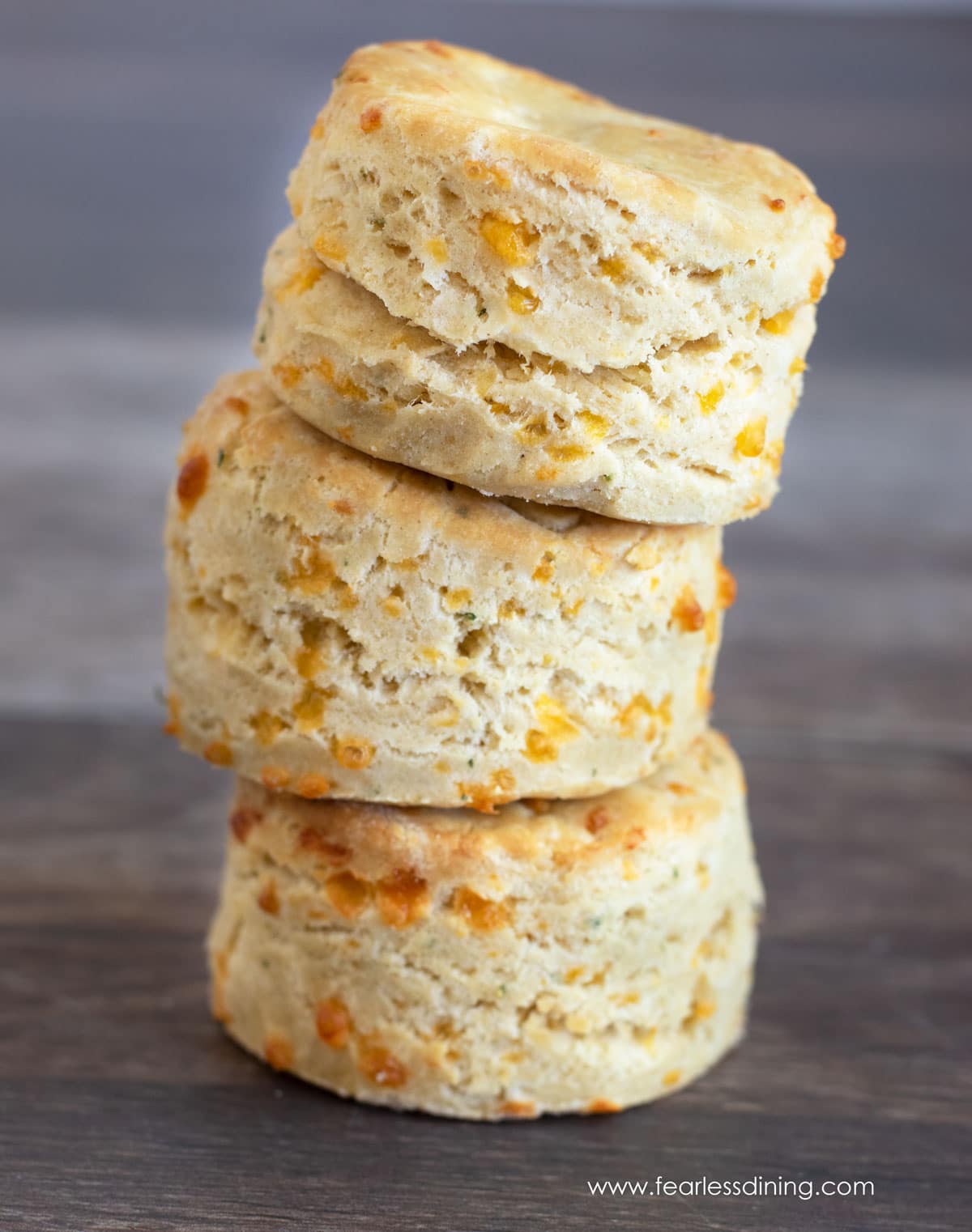 A stack of three gluten free cheddar biscuits.