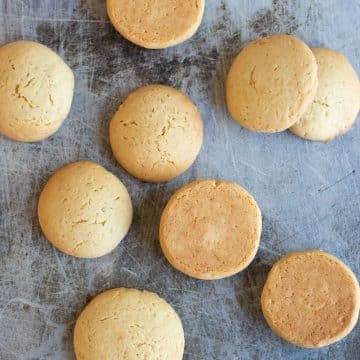 A cookie sheet with baked gluten free vanilla wafer cookies.