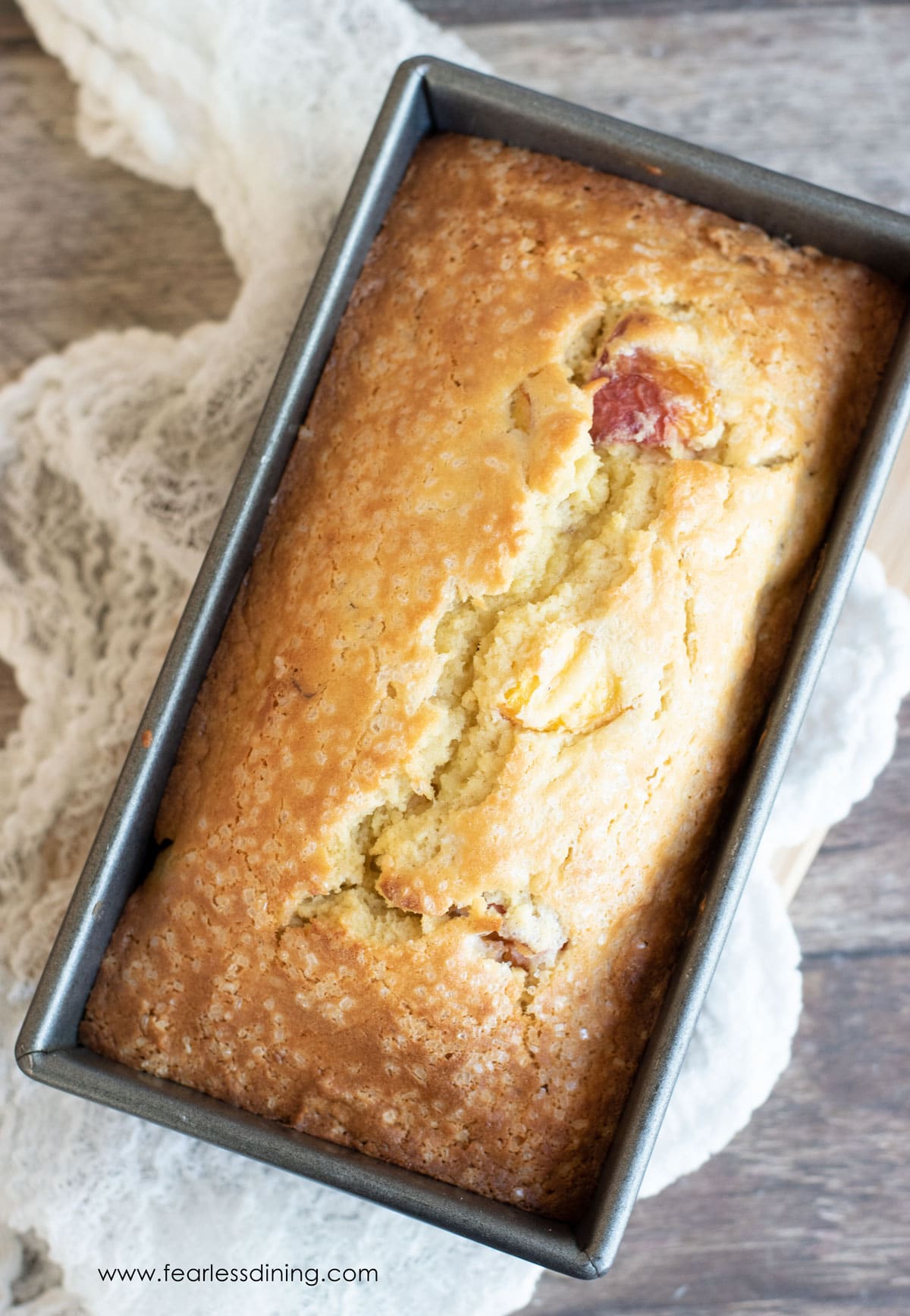 A baked peach cake in a loaf tin.