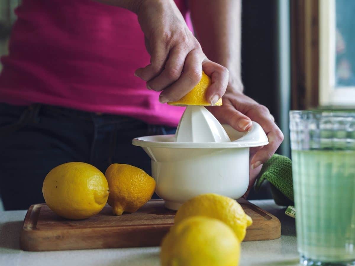 A photo of a person juicing lemons.