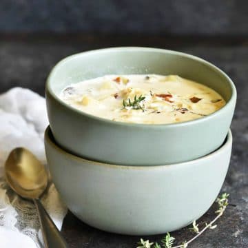 Two bowls of gluten free New England fish chowder on a table.