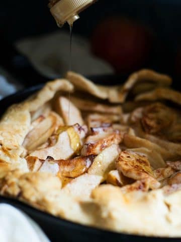 A photo of drizzling honey over the gluten free apple galette.
