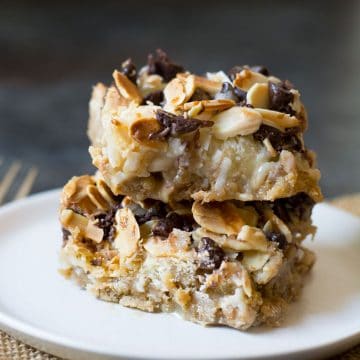 A stack of two gluten free magic bars on a white plate.