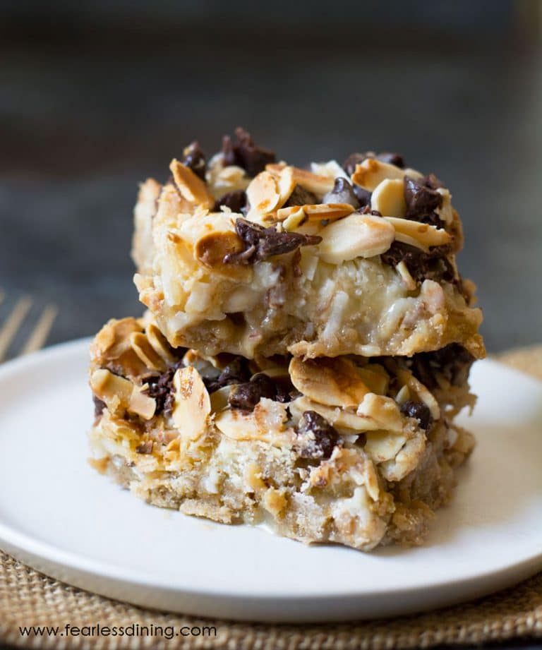 A stack of two gluten free magic bars on a white plate.
