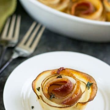 A roasted bacon potato rose on a plate.