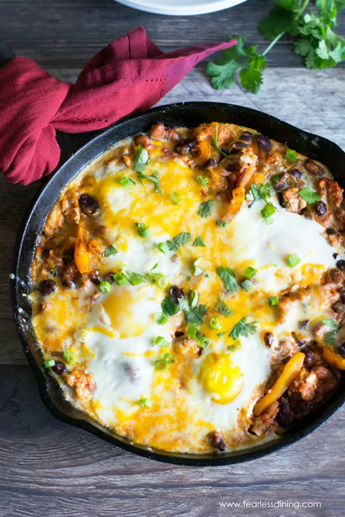 A cast iron skillet full of ground turkey shakshuka.