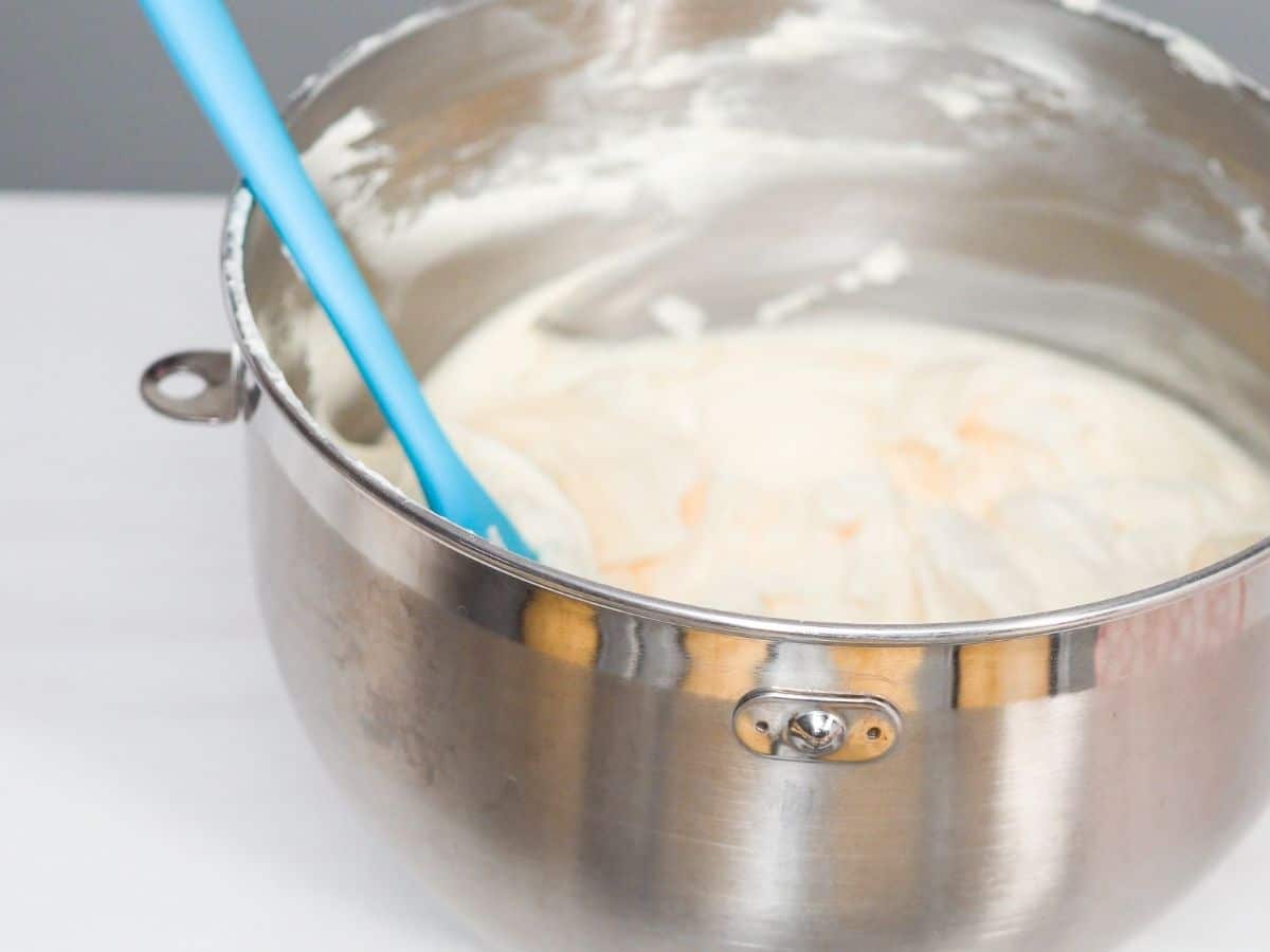 A silver bowl full of frosting.