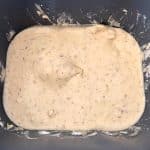 The bread batter in the bread machine after the mix cycle.