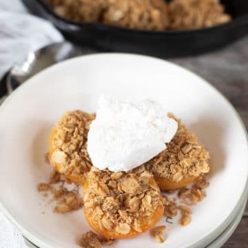 Gluten free apricot crisp topped with whipped cream.