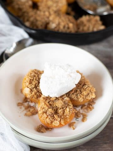 gluten free apricot crisp topped with whipped cream