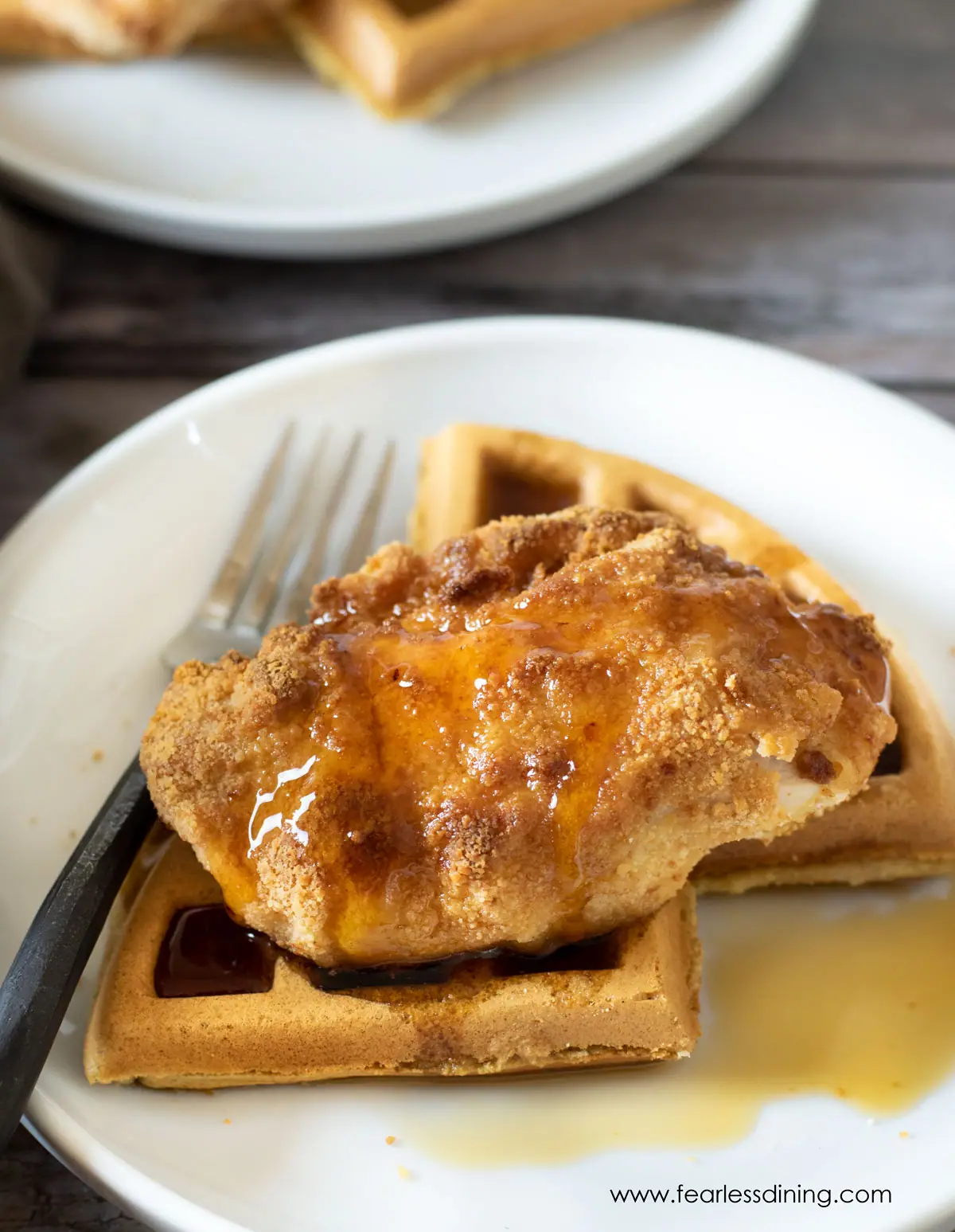 chicken and waffles on a plate with syrup