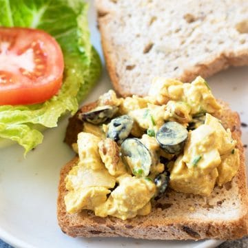 A chicken salad sandwich on a plate.