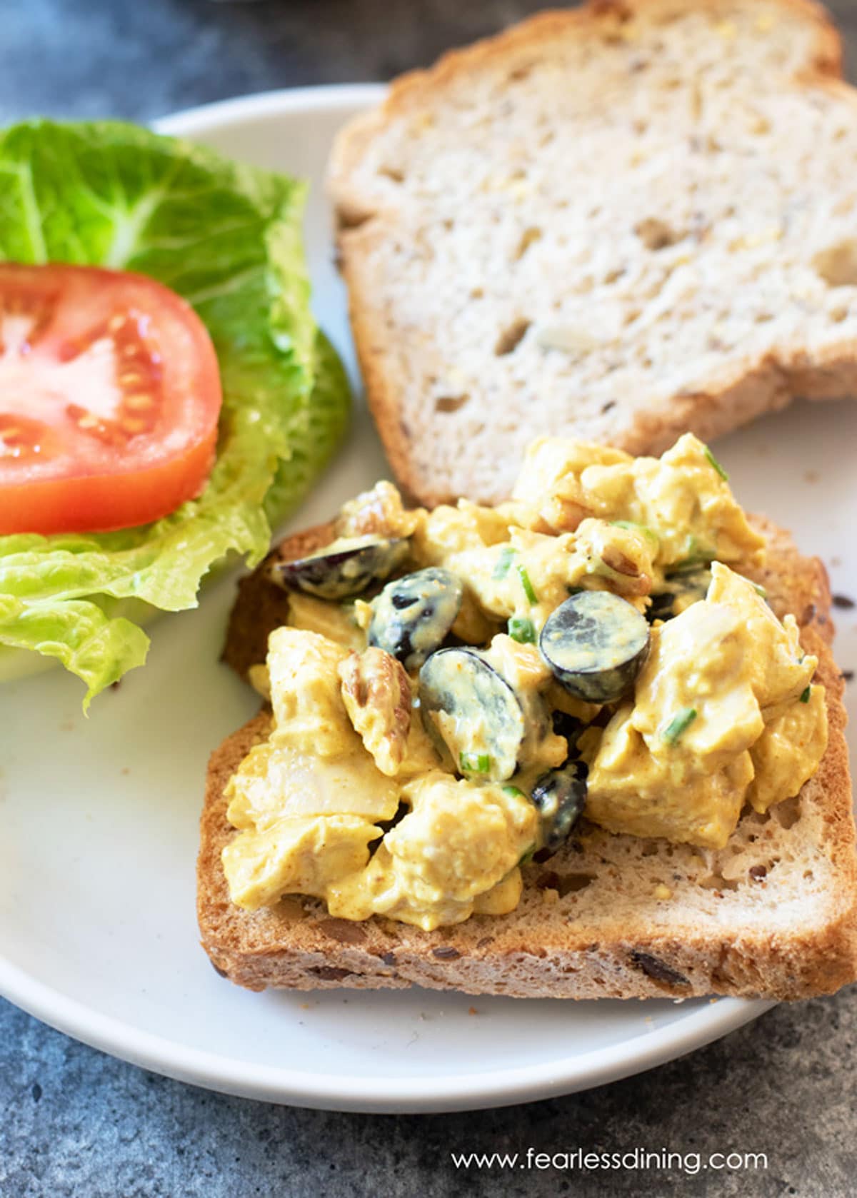 A chicken salad sandwich on a plate.