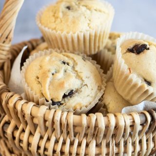 A basket full of vegan chocolate chip muffins.