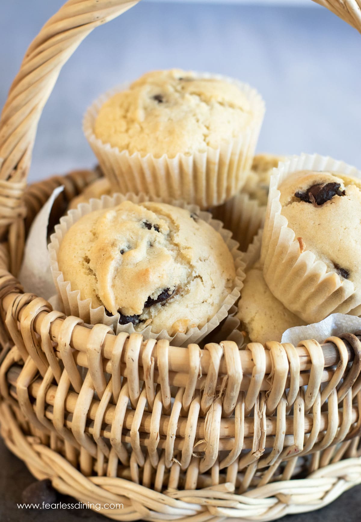 A basket full of vegan chocolate chip muffins.