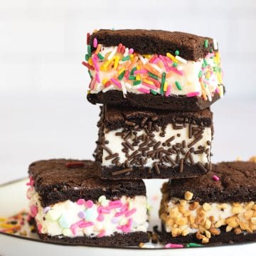 A stack of four gluten free ice cream sandwiches on a plate.