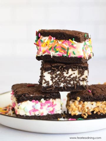 A stack of four gluten free ice cream sandwiches on a plate.