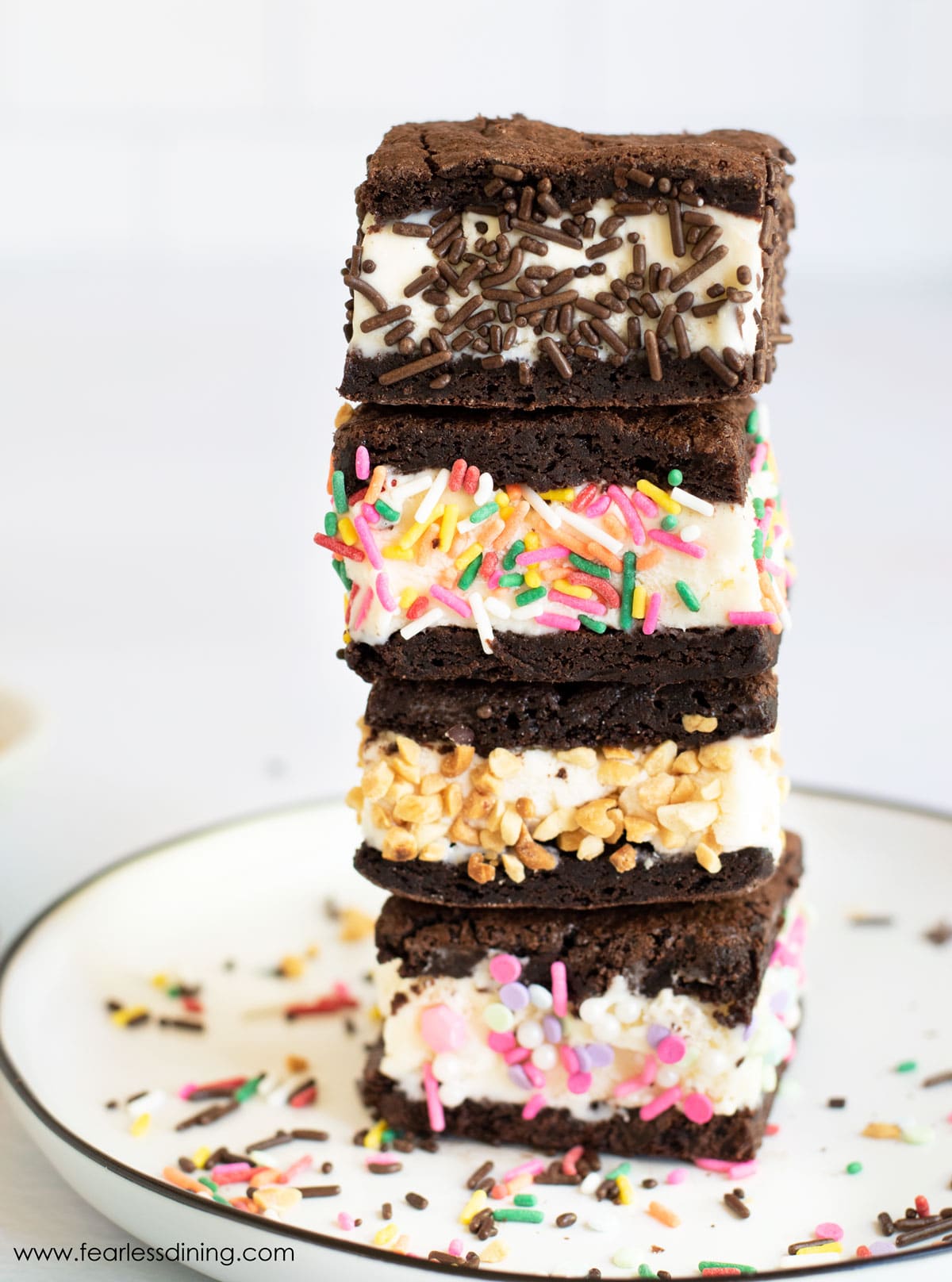 A stack of four gluten free ice cream sandwiches. Each is decorated with sprinkles.