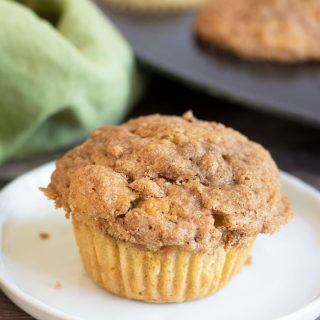 a peach streusel muffin on a plate