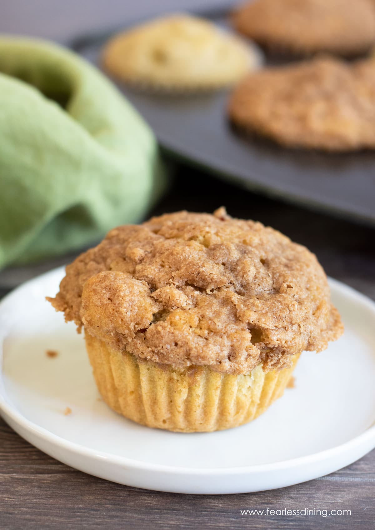 a peach streusel muffin on a plate
