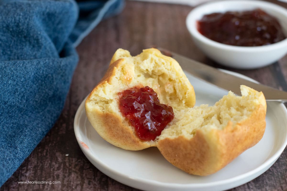 A gluten free popover cut in half with jam.