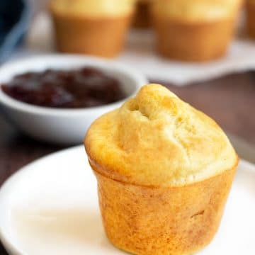 A single gluten free popover on a plate.