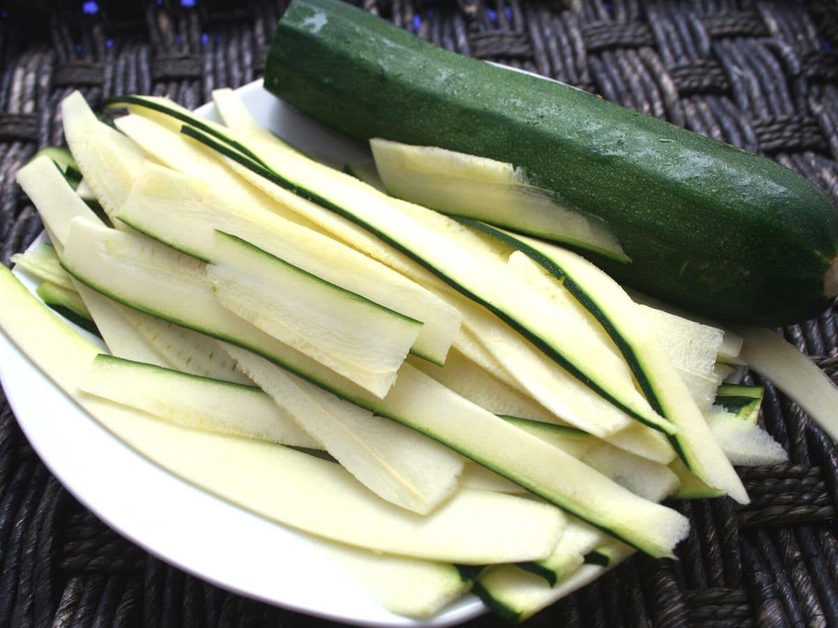 Horizontally sliced zucchini slices on a plate.