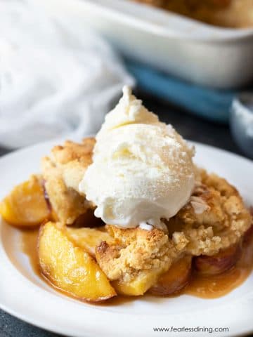 a plate full of peach cobbler topped with ice cream