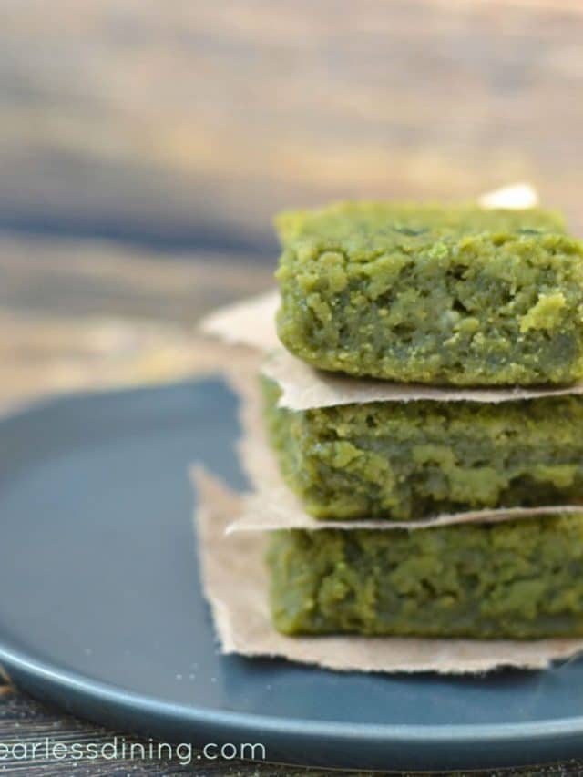 A stack of 3 pieces of matcha mochi on a grey plate.